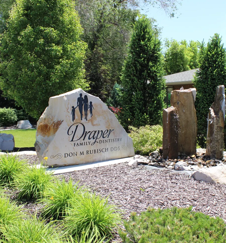 The stone sign outside the practice, reading Draper Family Dentistry, Don M. Rubisch DDS.