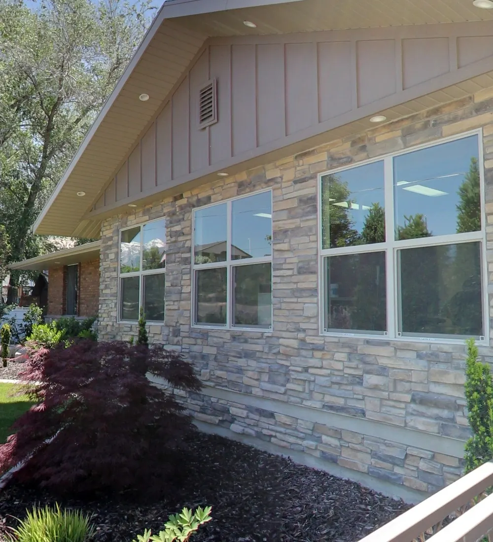 The stone and brick front of the Draper Parkway Dental building, with its gardens.
