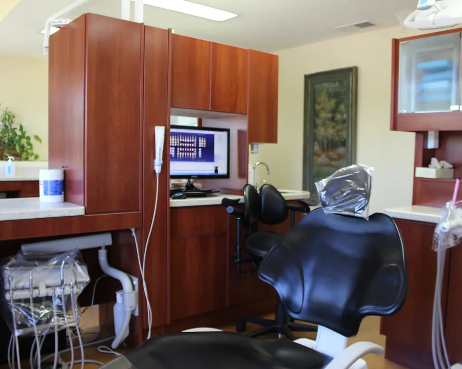 A treatment room at Draper Parkway Dental, with x-ray images on the monitor beside the chair.