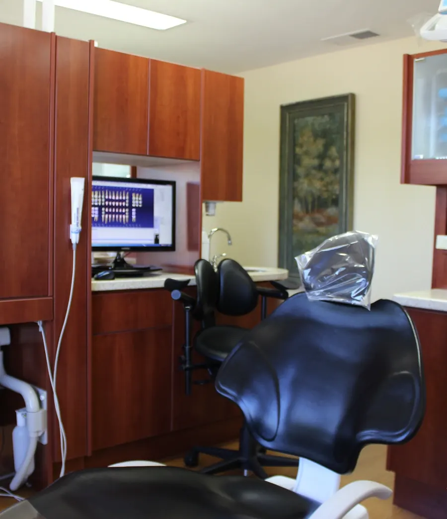 A treatment chair at Draper Parkway Dental, with cherry wood cabinets.
