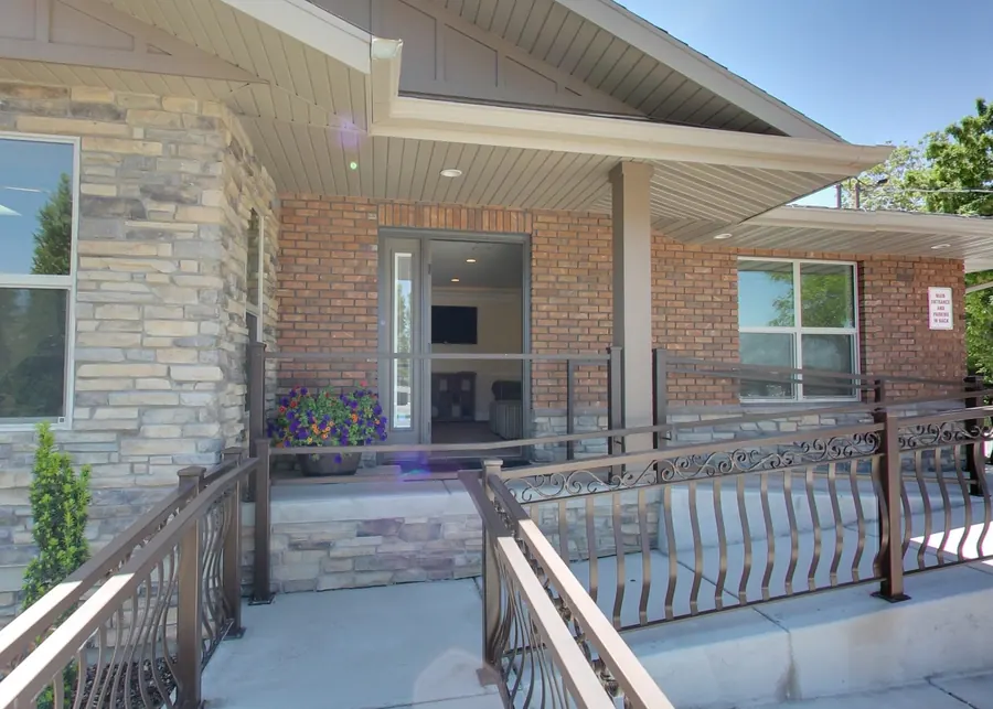 The front entrance of Draper Parkway Dental, with an accessible ramp and parking at the door.